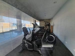 a gym with exercise bikes and a swimming pool at Sunvida Condo across SM City Cebu w/ WIFI and View in Cebu City