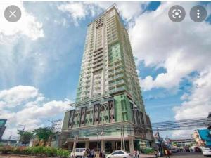 a tall building with people standing in front of it at Sunvida Condo across SM City Cebu w/ WIFI and View in Cebu City