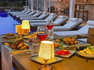 a table with plates of food and glasses of wine at Vista Del Amor Faralya in Fethiye