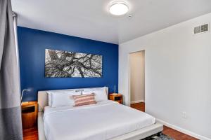 Un dormitorio con una pared de acento azul y una cama en Gorgeous 2BD next to the convention center and reading terminal en Filadelfia