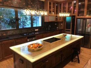 a kitchen with a bowl of fruit on a counter at Grand Serene Lakeside Bali Style Villa in Cyberjaya