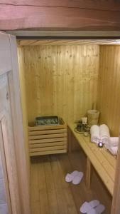 a small wooden sauna with a table and towels at Hotel Chez Toi in Oulx