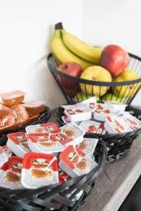 a basket of food and a basket of fruit at Aeonian Luxury Suites Asprovalta, Adults Only & Kids 12 Plus in Asprovalta