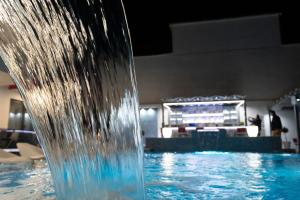 a close up of a water fountain in a swimming pool at Aeonian Luxury Suites Asprovalta, Adults Only & Kids 12 Plus in Asprovalta
