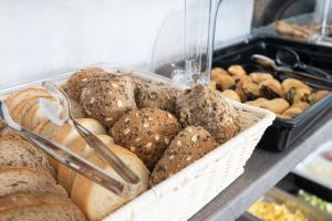 a bunch of different types of bread in a basket at Aeonian Luxury Suites Asprovalta, Adults Only & Kids 12 Plus in Asprovalta