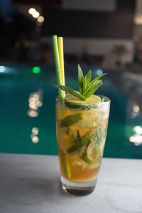 a drink with a lime and mint on a table at Aeonian Luxury Suites Asprovalta, Adults Only & Kids 12 Plus in Asprovalta