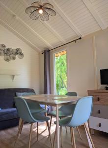 a dining room with a table and chairs at Camping Du Port De Plaisance in Péronne