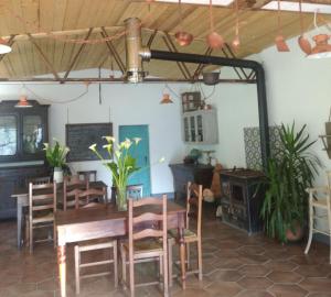 a dining room with a wooden table and chairs at Agriturismo LE CASE ROTTE in Balestrino +81 photos