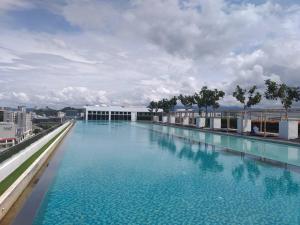 a large swimming pool on the roof of a building at FLYPOD - Blue Sky Apartment 4-5pax , Sutera Avenue in Kota Kinabalu