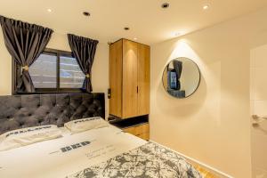 a bedroom with a large bed and a mirror at orel's Top apartment in Eilat