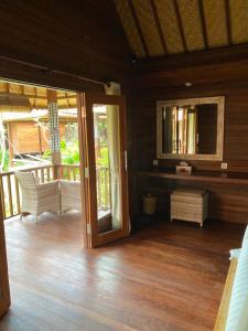 a room with a door open to a porch at The Niti Hut's Lembongan in Nusa Lembongan
