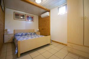 a bedroom with a bed and a window at Camping Linus in Marina di Massa