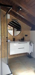 a bathroom with a white sink and a mirror at Refugio del Cares in Ortiguero