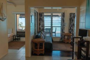 a living room with a couch and a table at Take-A-Break Islander on the Beach Villa - Vaimaanga in Rarotonga