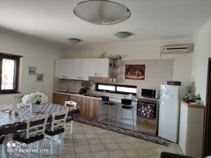 a kitchen with a table and a kitchen with a refrigerator at Or Son Sano in Lettere