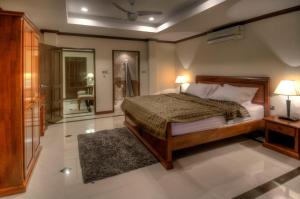 サムイ島にあるEmerald Beach-Front Apartments Fishermans Villageの大きなベッドとバスルームのある寝室