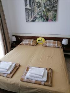 a bed with two towels on top of it at Apolon 2 in Sozopol +17 photos