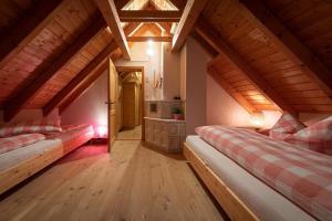 a attic room with two beds and a fireplace at Chalet Abnona in Wieden