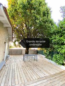 a bench sitting on top of a wooden deck at Studio cosy aux portes de Bordeaux et Saint Emilion in Yvrac +8 photos