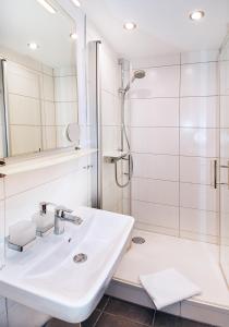 a bathroom with a sink and a shower at 8peaks in Pfronten