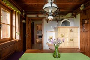 a vase of flowers on a table in a kitchen at Chalet Abnona in Wieden