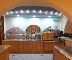a kitchen with an archway in a restaurant at Erato Hotel in Kokkini Khanion