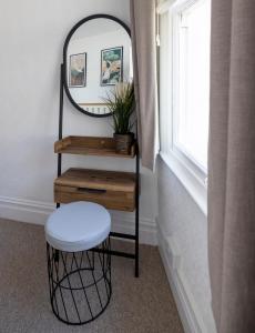 a stool and a mirror in a room with a window at Modern Cottage for Couples, Parking, 3 Min 2 Beach in Beer