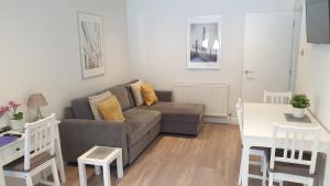 a living room with a couch and a table at Large modern self contained apartment in Lymington in Lymington