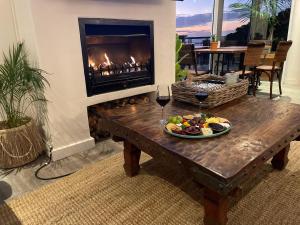 a table with a plate of food and a fireplace at Royal Boutique Hotel in Cape Town