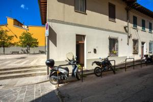 two motorcycles parked in front of a building at La Cupolina Rosa in Florence