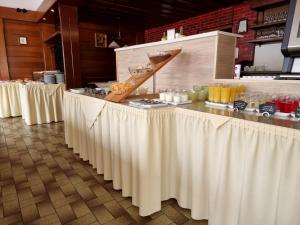 a buffet line with white tables with food on them at Pension Bergfried in Hallstatt
