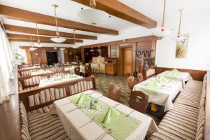 a restaurant with tables and chairs in a room at Pension Bergfried in Hallstatt