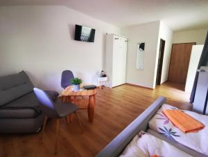 a living room with a couch and a table at Pension Bergfried in Hallstatt