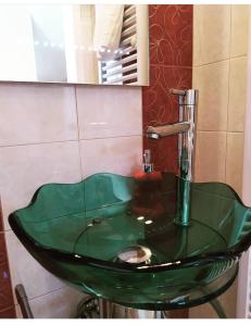 a green sink in a bathroom with a mirror at Chara host in Olympia +22 photos