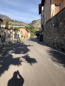 a shadow of a person taking a picture of a street at ON the RAIL by Arcotrilogy-Homes in Arco