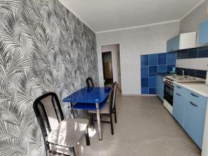 uma cozinha com uma mesa azul e cadeiras em Home On Gagarina em Kropyvnytskyi