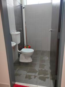 a bathroom with a toilet and a shower stall at Juliana Homestay in Jitra