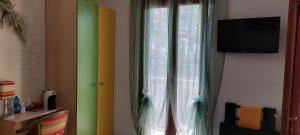 A television and/or entertainment centre at AFFITTACAMERE L'ARCOBALENO