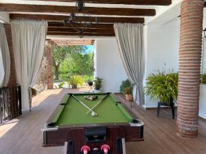 a living room with a pool table in a room with a ceiling at Villa Zahar in Periana