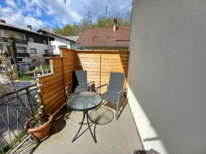 a patio with a table and chairs on a balcony at Lovely 2-bedroom appartment with free parking in Dobrova