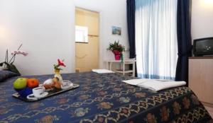 a hotel room with a tray of food on a bed at Hotel Residence S.Angelo in Ischia