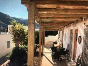 eine Terrasse mit einer hölzernen Pergola auf einem Haus in der Unterkunft apartamento in Almería