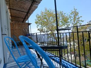 a balcony with blue chairs and a table at Regina Margherita in Positano