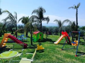 a group of playground equipment in the grass at B&B Villa Molinari in Campagna