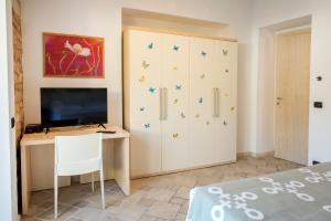 a bedroom with a desk and a cabinet with stars on it at A07 - Poggio, delizioso bilocale con portico in Poggio