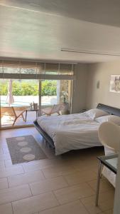 a bedroom with a large bed and a balcony at Villa San Marco chambre d hôtes in Lorgues