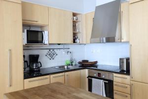 a kitchen with a sink and a microwave at 2ndhomes Premium 1BR apartment with Sauna and Balcony in Kamppi Center in Helsinki
