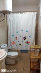 a bathroom with a shower curtain with fish on it at Casa Beja in Sant Francesc Xavier
