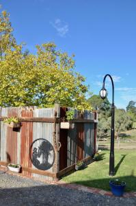 a fence with a gate with a picture of a horse on it at The stables in Wandin North