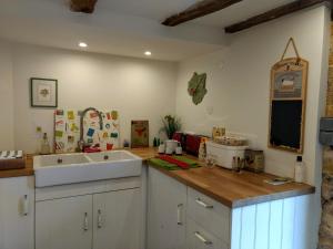 a kitchen with a sink and a counter top at La Lezardiere in Gourdon-en-quercy
